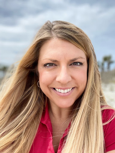 A photo of Mandy McMahon, who has blonde hair and is wearing a red shirt.