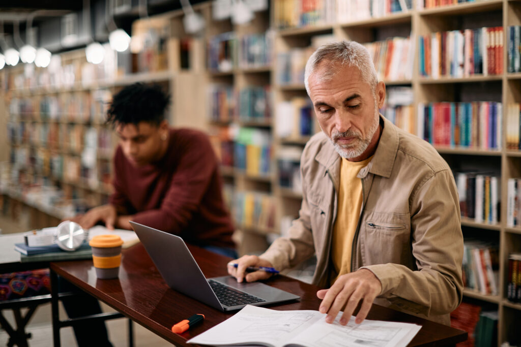 Older man studying with laptop Getty