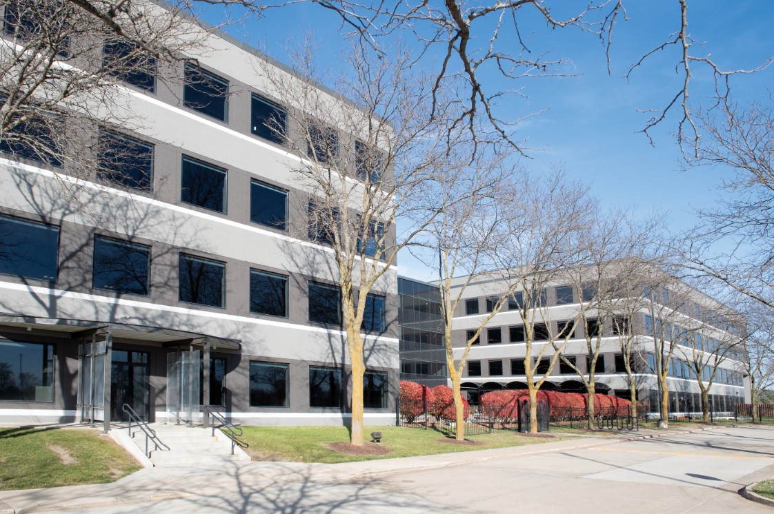 A grey office building with square windows in rows