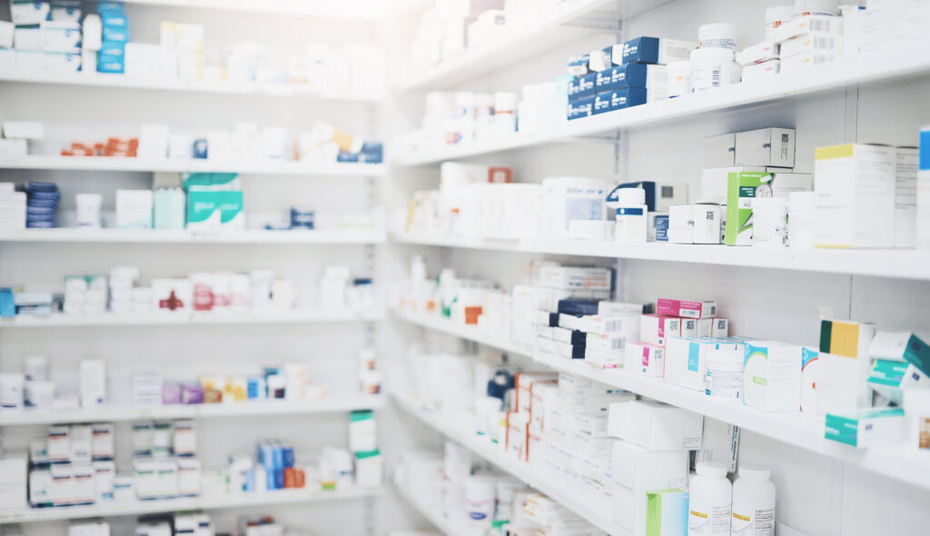 Pharmacy, medicine and box with healthcare shop, shelf and prescription care pills. Medical, retail store and supply of health supplements, vitamins and minerals for vitality and wellness dispensary